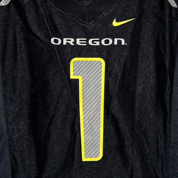 Black football jersey with 'OREGON' and number '1' on a dark background