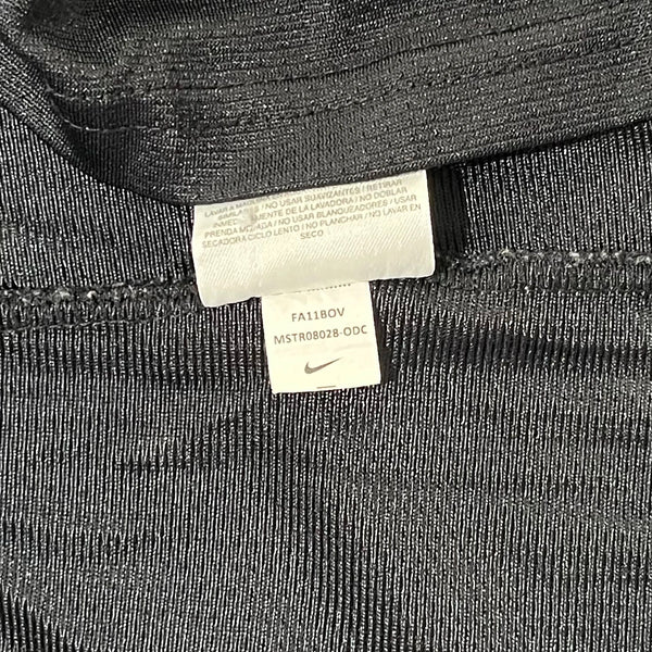 Close-up of a black fabric texture with a Nike tag on it.