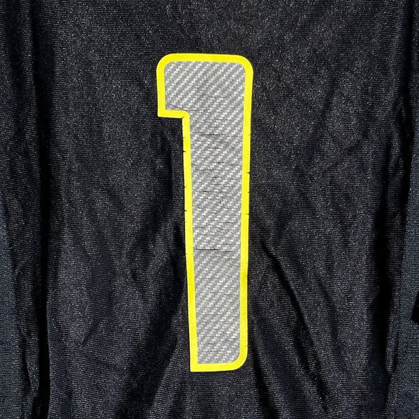 Black fabric with a large white number '1' on a yellow border