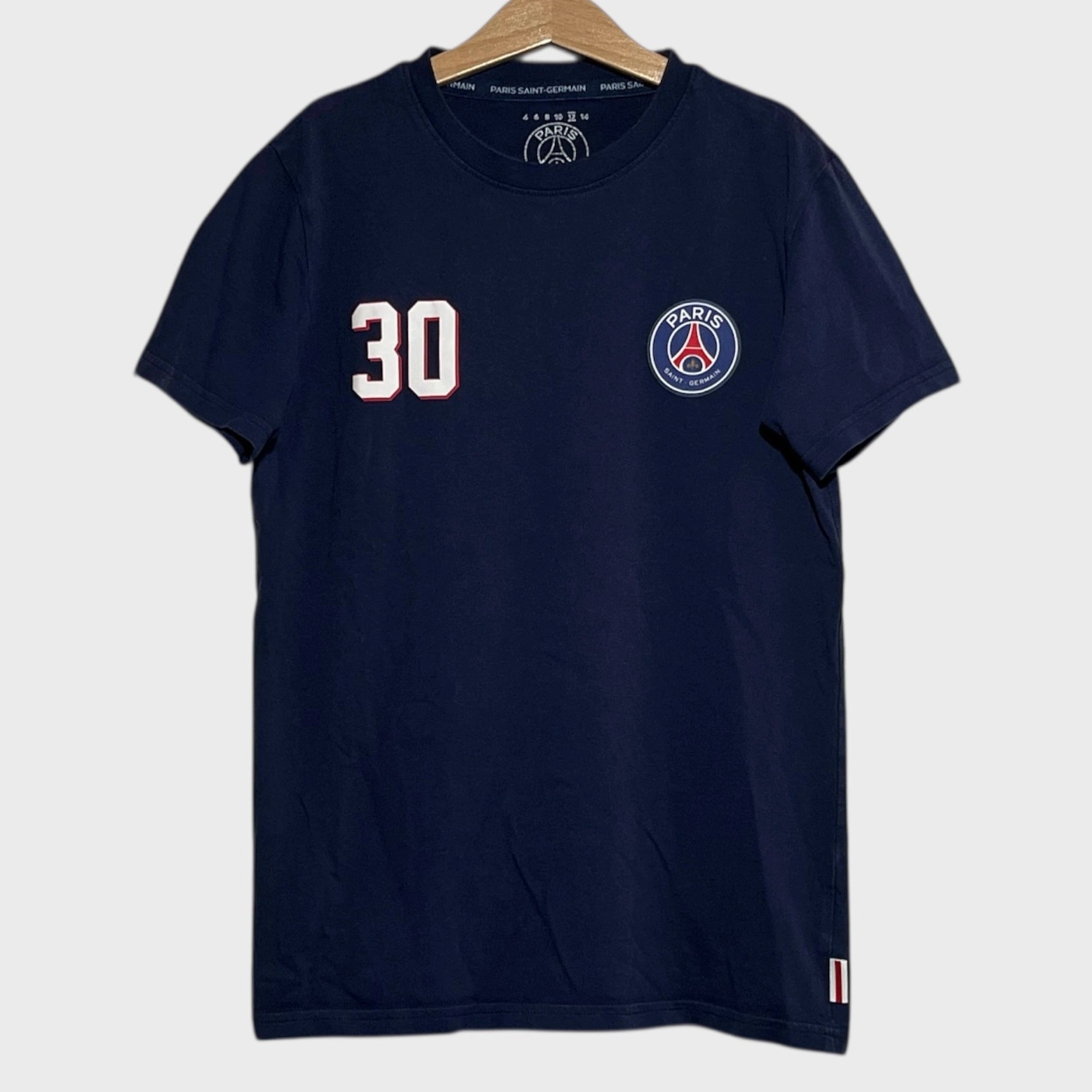 Navy blue t-shirt with number 30 and PSG logo on a hanger against a white background