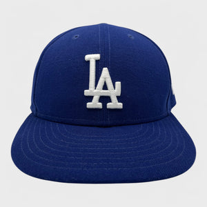 Blue Dodgers baseball cap with white LA logo on a light gray background