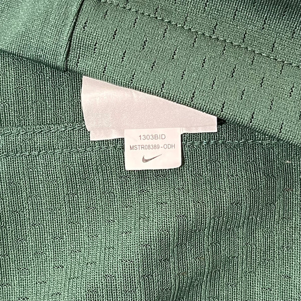 Close-up of a green Nike shirt with a tag showing product details.
