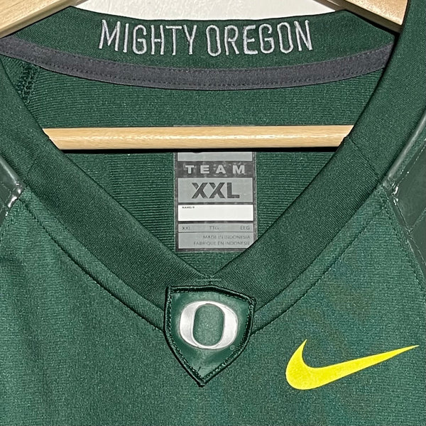 Green football jersey collar with 'Mighty Oregon' text and Nike logo.