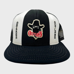Black and white trucker hat with 'Outlaws' logo on a gray background