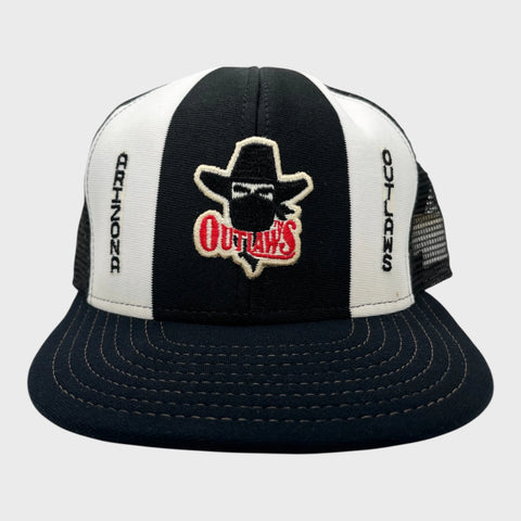 Black and white trucker hat with 'Outlaws' logo on a gray background