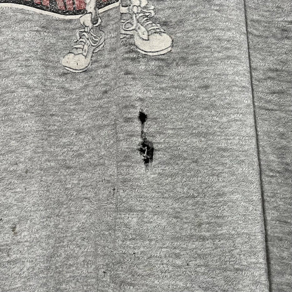 Close-up of a gray shirt with a hole.