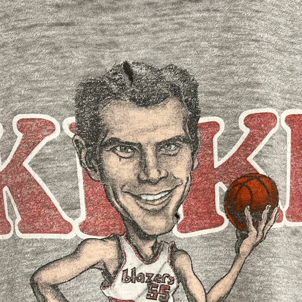 Caricature of a basketball player holding a ball with 'Kiki' text on a gray background
