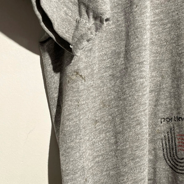 Close-up of underarm of gray tee shirt.