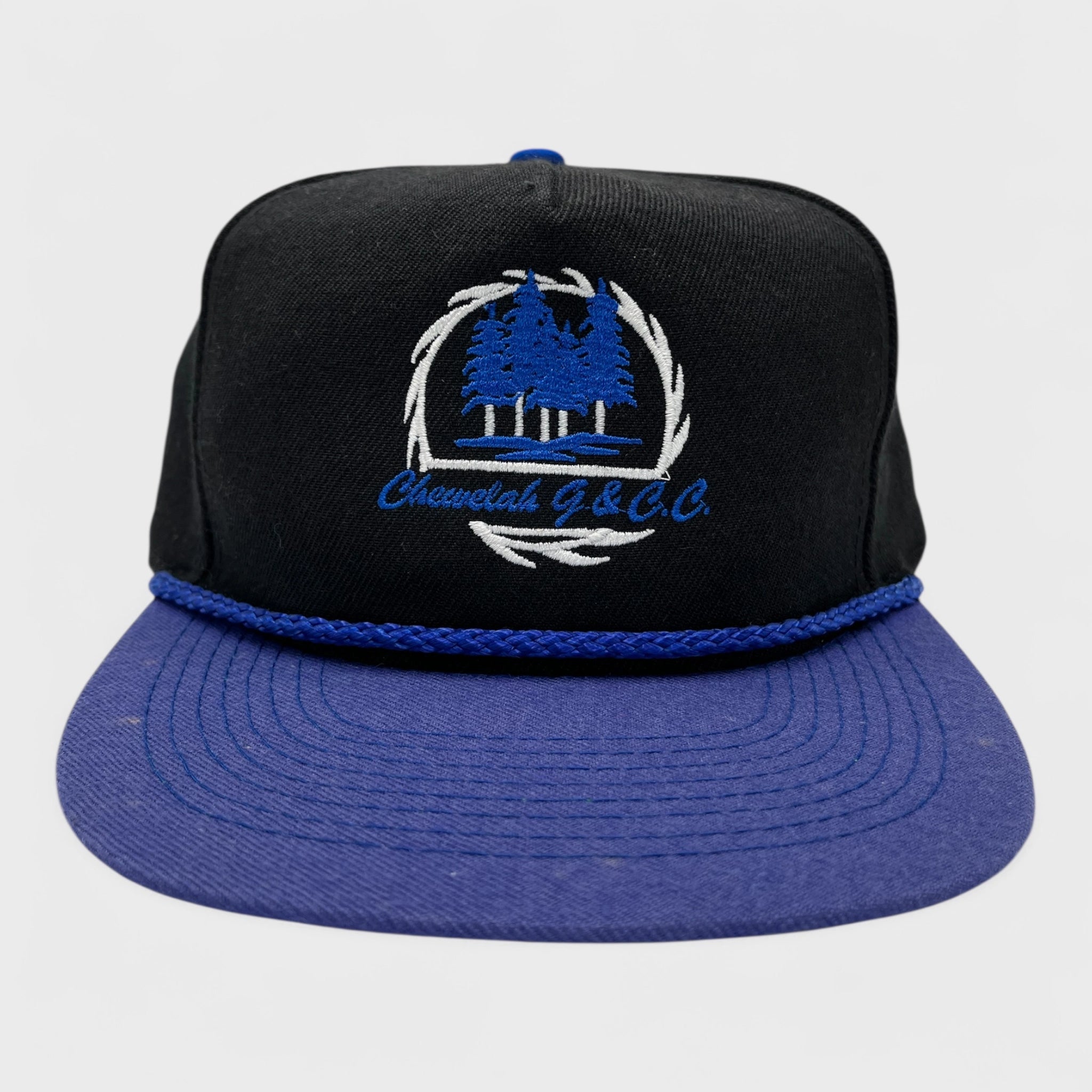 Black and blue cap with embroidered logo on a light gray background