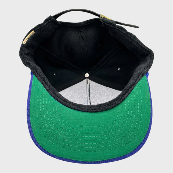 Black cap with a white interior on a light gray background