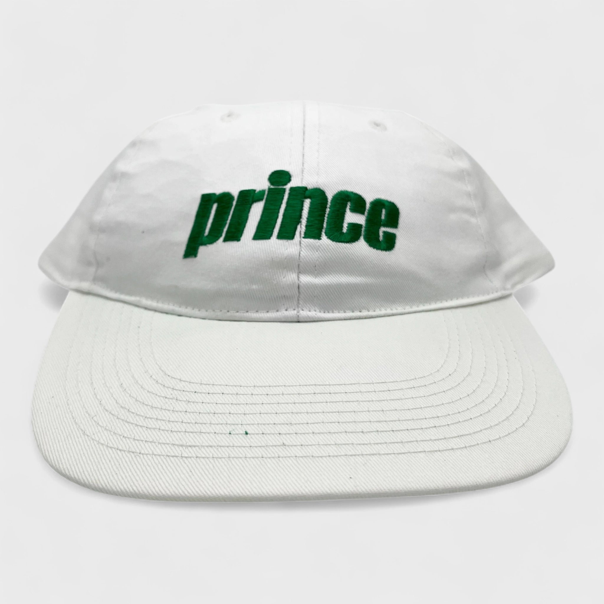 White cap with 'prince' in green on a white background
