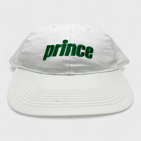 White cap with 'prince' in green on a white background