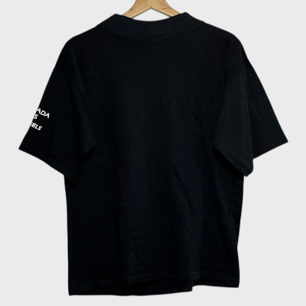 Black t-shirt with text on sleeve against a white background