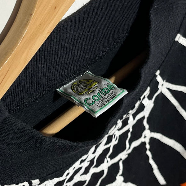 Close-up of a black shirt with a brand tag and basketball hoop design.