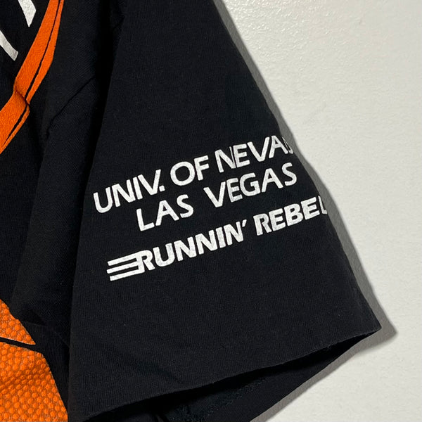 Black tee shirt sleeve with 'UNIV. OF NEVADA, LAS VEGAS RUNNIN' REBELS' text on a light gray background