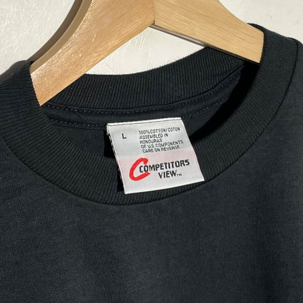Black t-shirt with a visible label on a wooden hanger