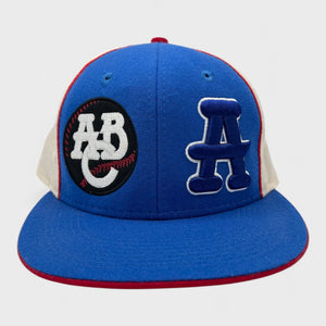 Blue and white baseball cap with logos on a light gray background