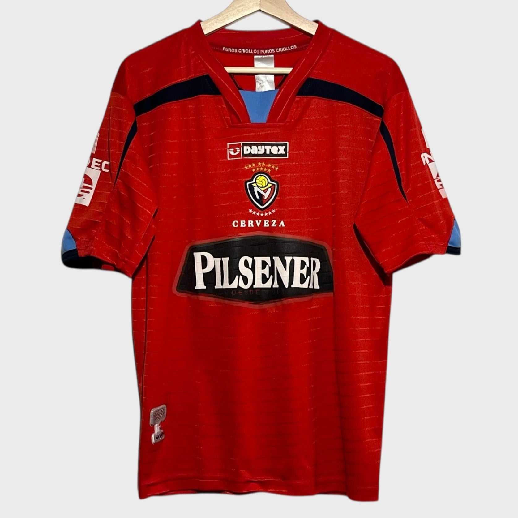 Red soccer jersey with visible branding on a white background