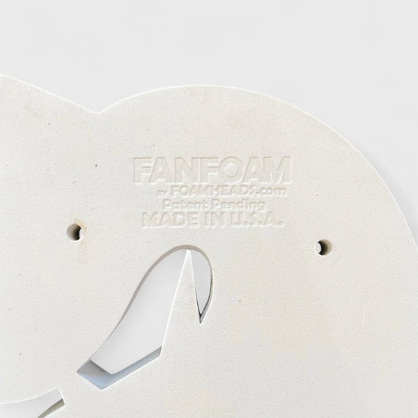 Close-up of a white foam block with 'FANFOAM' branding on a light gray background
