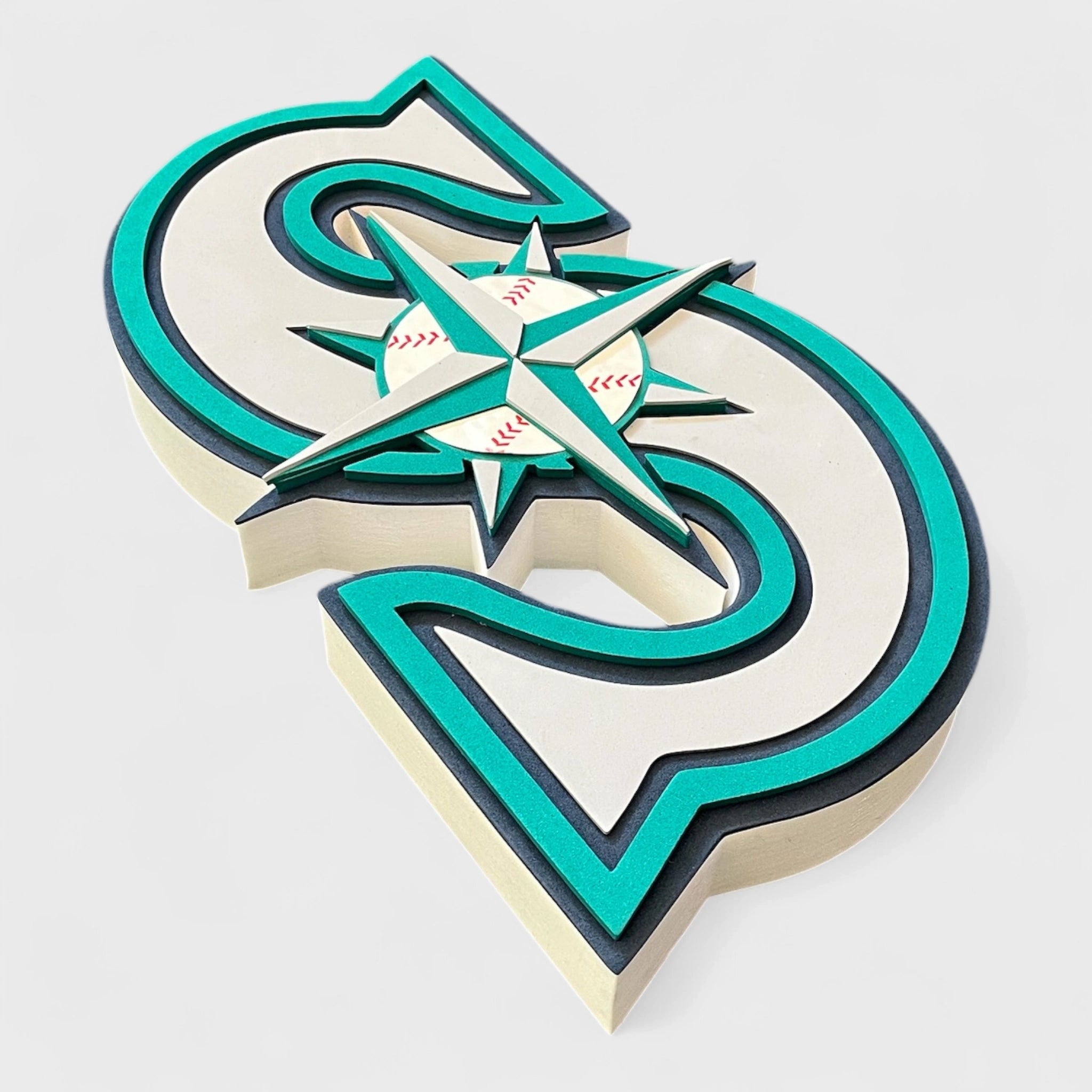 3D Seattle Mariners logo with teal and beige colors on a white background