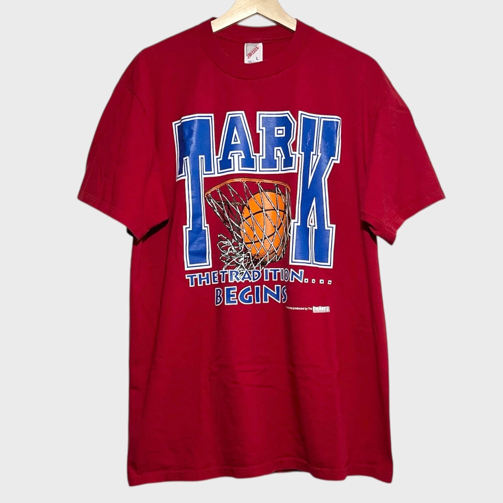 Red t-shirt with basketball graphic and text on a white background
