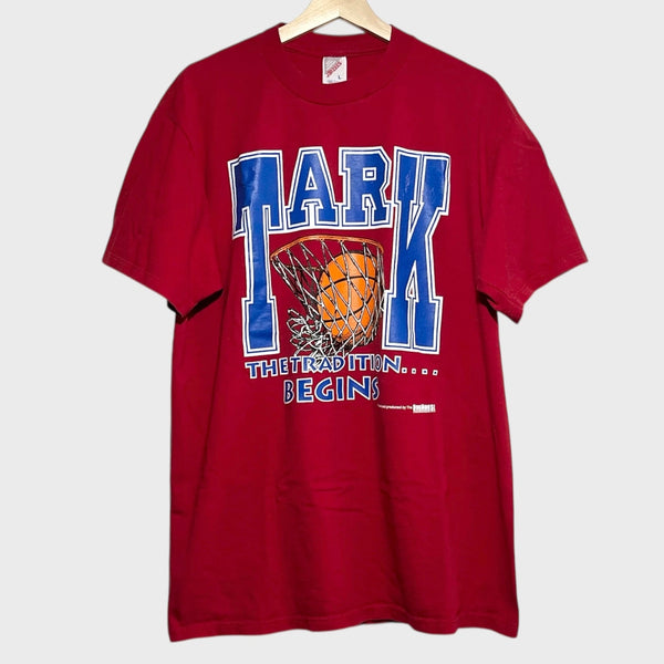 Red t-shirt with basketball graphic and text on a white background