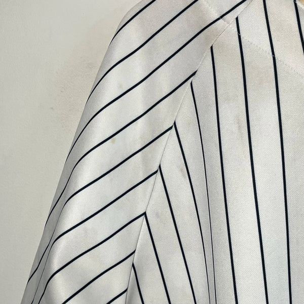 Close-up of a white baseball jersey on a white background