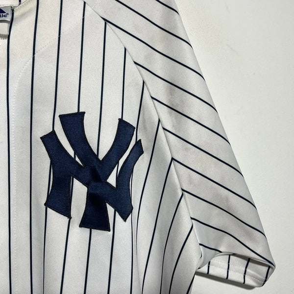 Baseball jersey with pinstripes and a prominent logo on a white background