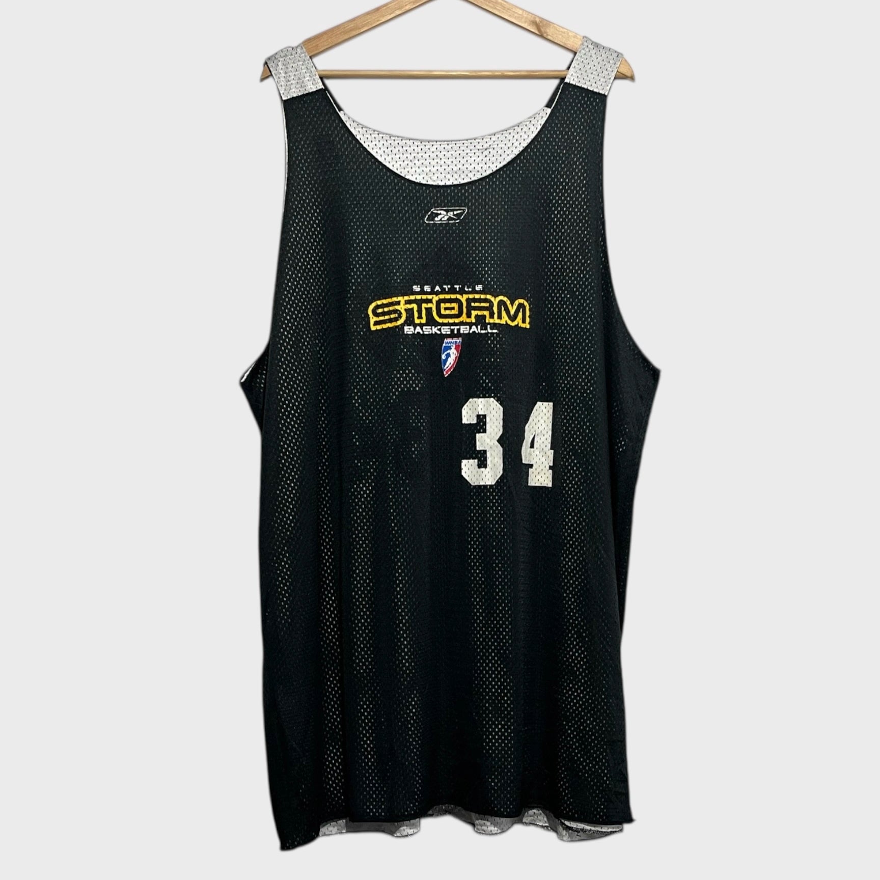 Black basketball jersey with 'Seattle Storm' and number '34' on a white background