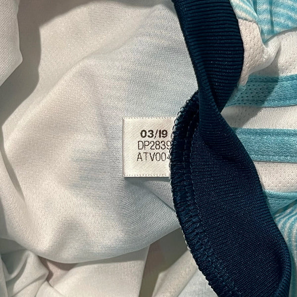 Close-up of a label on a garment with visible text and numbers.