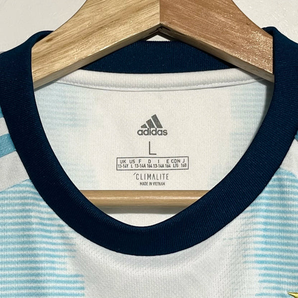 Close-up of a shirt with Adidas label on a hanger