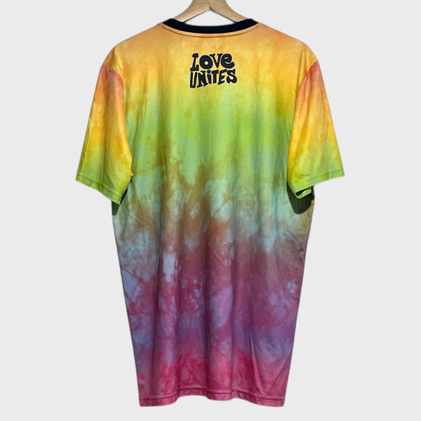 Tie-dye t-shirt with 'LOVE UNITES' text on a hanger against a white background