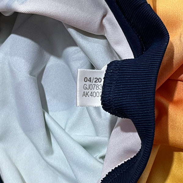 Close-up of fabric with a label showing text and numbers.
