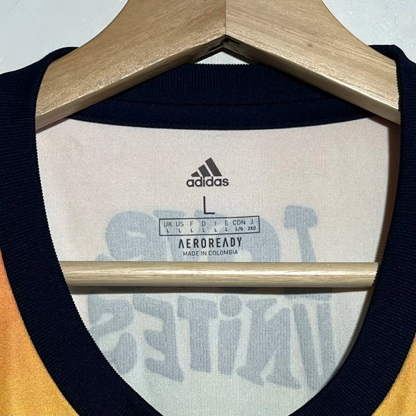 Adidas label on a garment with 'Aeroready' text on a hanger